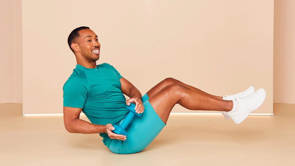 A man performing Russian Twists exercise with a dumbbell